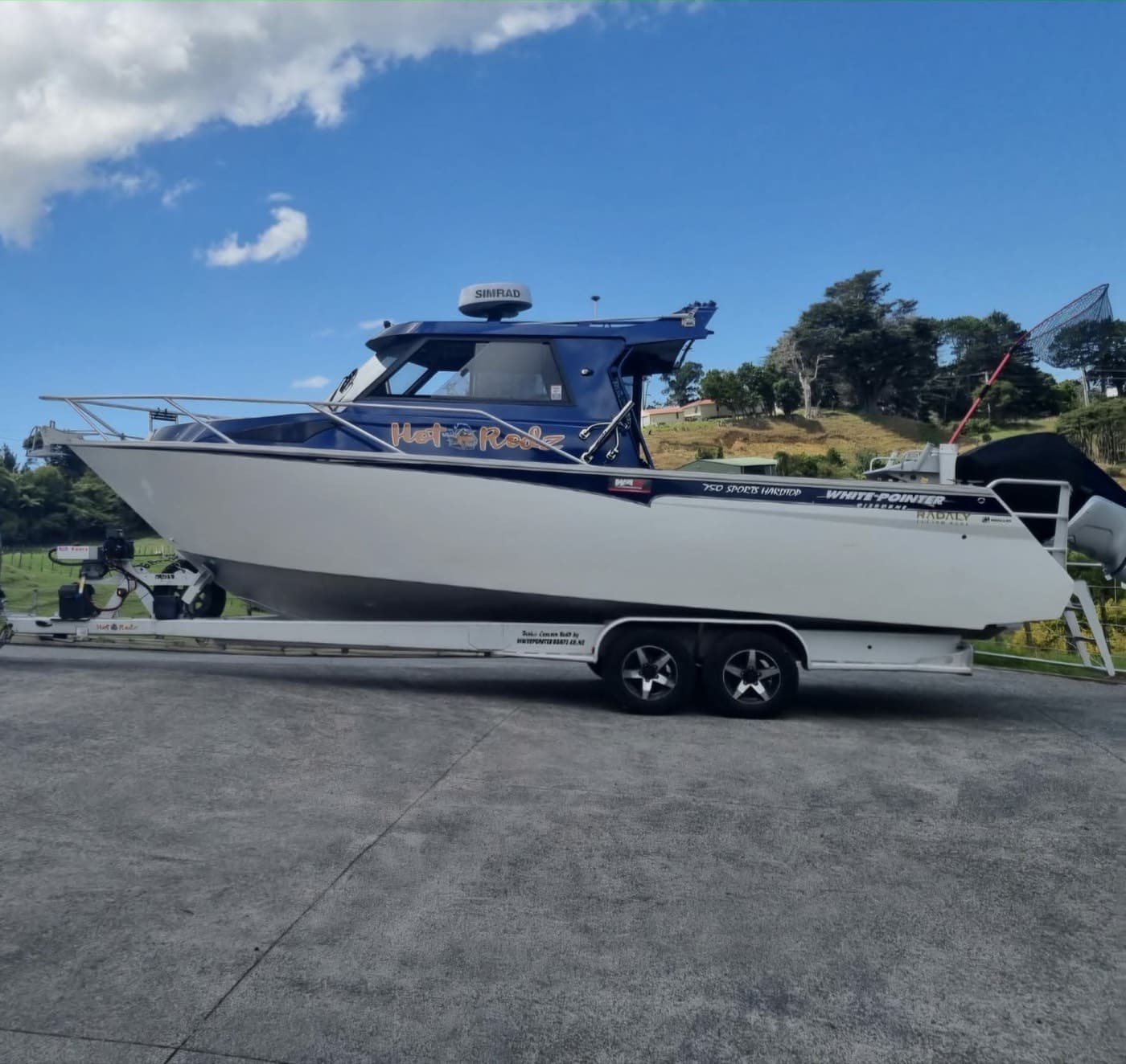 Hardtop boat sitting on its tandem axle trailer