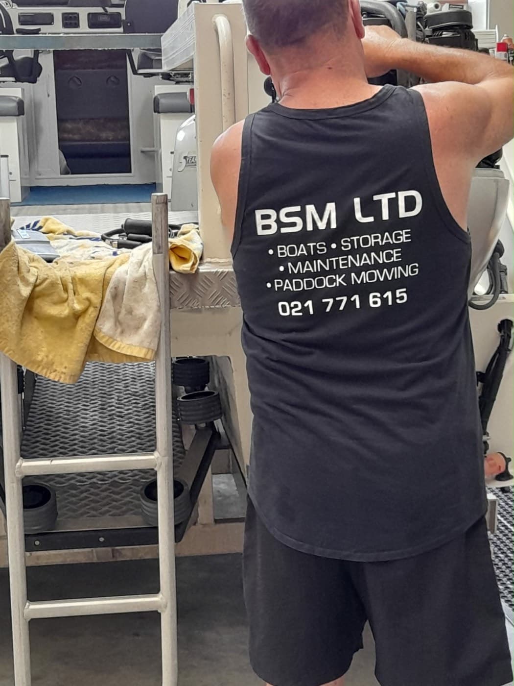 BSM Ltd workshop with a boat up on the hoist